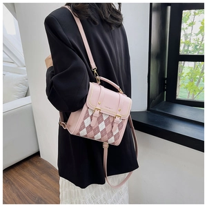 Detail of pink quilted diamond pattern and double buckle on a mini backpack for women