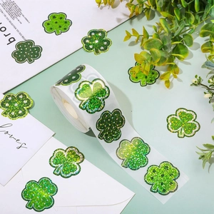 Close-up of sparkling green glitter clover stickers used for Saint Patrick's Day envelopes