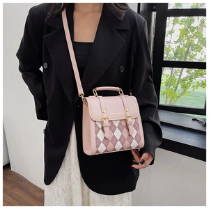 Detail showing pink quilted leather handbag with gold lettering and metallic hardware