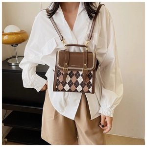 Detail of retro argyle pattern and brown leather straps on this stylish backpack