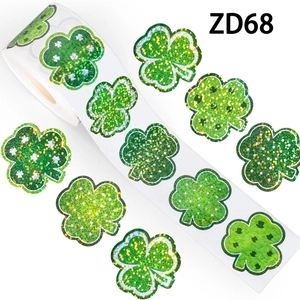 Roll of 500 green glitter clover stickers with various patterns for St. Patrick's Day