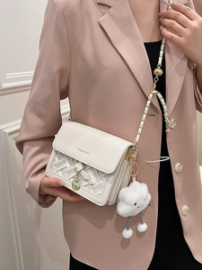 White crossbody square bag with woven texture, metal chain strap, and fluffy cloud charm