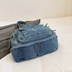 Minimalist denim blue shoulder bag with multi-pocket design and vintage washed finish