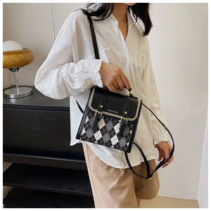 Detail of color-block quilted mini backpack with gold hardware and fashion logo