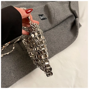 Detailed view of silver metallic sequin chainmail texture on a woven shoulder bag