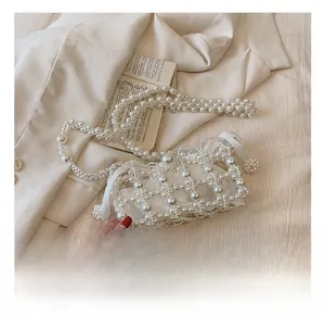 Detailed shot of handmade pearl woven evening bag with drawstring satin lining