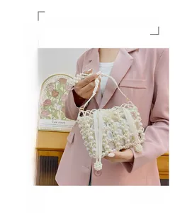 Detailed view of handmade pearl woven bucket bag with silk drawstring lining