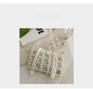 Close-up of pearl beaded bucket bag with drawstring satin lining and elegant handle