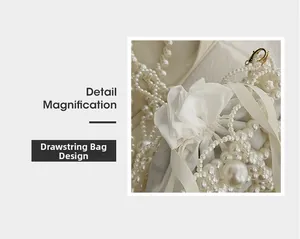 Detail showing the elegant white beaded drawstring design and pearl texture on the bucket bag