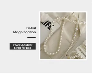 Detail of beaded pearl handbag strap with varying sized round pearls on beige fabric