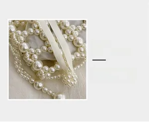 Macro view of woven white pearls and ribbed ribbon details on this French style bag