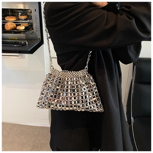 Detailed macro view of silver metallic sequins and chain strap on a stylish shoulder bag