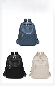 Detailed view of women's backpacks in blue, black, and off-white with floral patterns