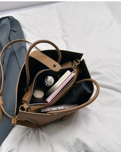 Internal view of brown pebble leather tote bag showing spacious compartments with essentials