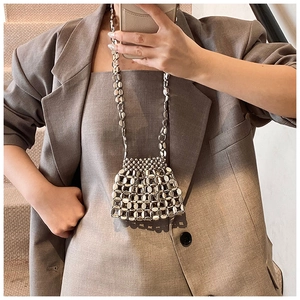 Detailed view of silver metallic woven mesh bag with bead chain for fashion styling