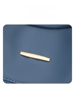 Detailed macro view of blue faux leather texture and polished gold metal bar hardware