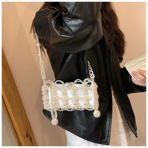 Detail of handmade pearl woven crossbody bag with satin lining and wavy edge finish