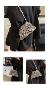 Detail of silver beaded woven crossbody bag showing hollow metal sphere pattern and texture