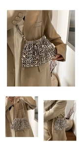 Detailed close-up of woven silver metallic sequins and chain strap on a vintage crossbody bag