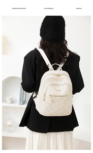 Detail of floral embossed cream PU leather backpack with gold metal zippers and pockets