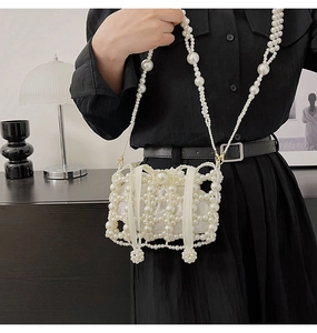 Detail of beaded pearl bucket bag with hollow woven structure and satin inner pouch
