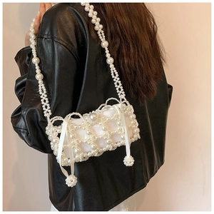 Close-up of handmade pearl woven crossbody bag with silk satin drawstring inner lining