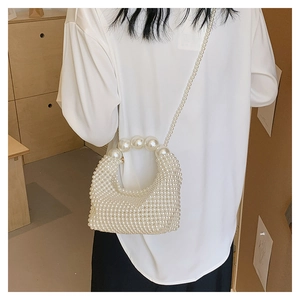 Close-up of handmade white pearl beaded evening bag with textured craftsmanship