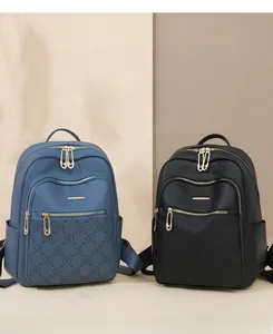 Detail of navy and black stylish backpacks featuring 3D floral embossing and gold hardware