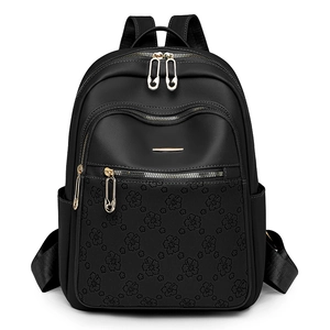 Fashionable black water-resistant women backpack with floral embossing and gold pin zippers