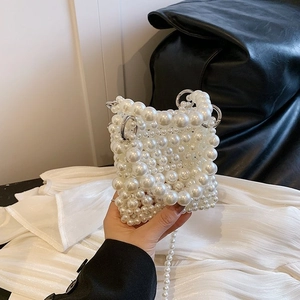 Elegant white pearl woven mini handbag with silver metal handles and long shoulder strap