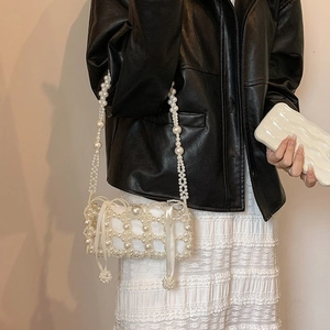 Elegant white pearl woven mini handbag with satin lining and decorative ribbon strap