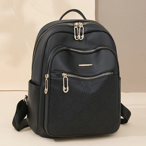Fashionable black women's backpack with floral embossing and gold zipper accents