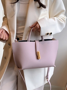Elegant light purple litchi grain leather tote bag with gold buckle and adjustable strap