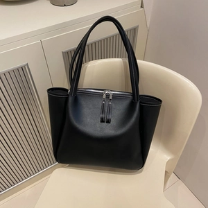 Classic black tote bag with white contrast stitching and silver zipper for daily commute