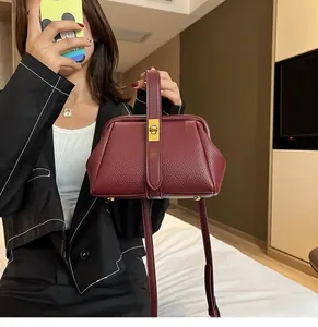 Burgundy lychee grain leather handbag with vintage doctor bag frame and gold metal clasp