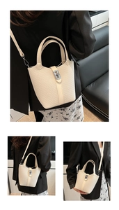 Close-up of woven bucket bag featuring premium texture, leather strap, and silver metal twist lock