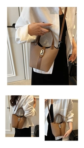 Detailed view of brown woven bucket bag featuring leather trim and silver metal twist lock