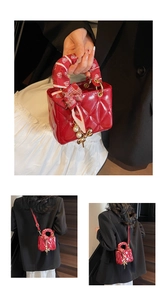 Detail of red quilted mini bag featuring silk scarf handle and pearl bow charm accessory