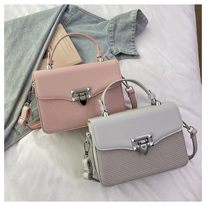 Close-up of contrast stitching bags with woven texture and silver metal buckle
