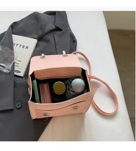 Detail view of pink leather shoulder bag interior showing large capacity and zipper pocket