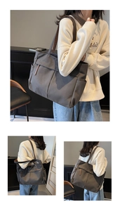 Close-up of charcoal gray canvas tote bag featuring functional front pockets and leather tabs