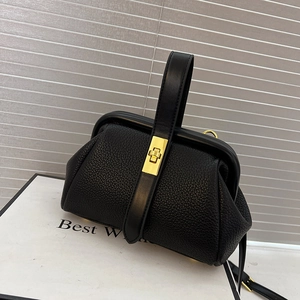 Black pebble leather doctor bag with gold twist lock and sturdy top handle