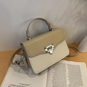 Minimalist color-block crossbody handbag in beige and cream faux leather with metal stud lock