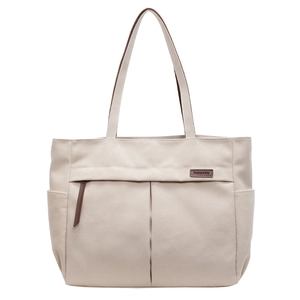 Large beige canvas tote bag with brown leather handles and spacious side pockets