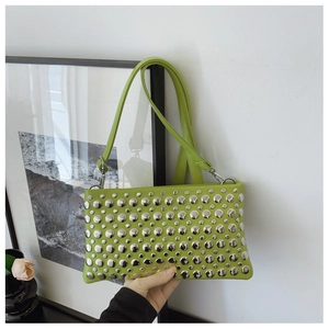Close-up of bright green shoulder bag featuring polished silver round metal rivets and studs