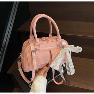 Pink glossy patent leather Boston bag with double pockets and lace pearl pendant detail