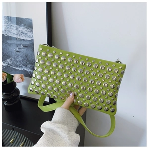 Close-up of vibrant green PU leather shoulder bag with silver metallic stud details