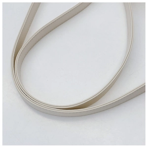 Detail of off-white leather shoulder strap with precise stitching and smooth edge finish