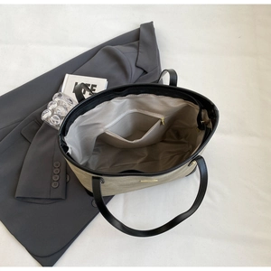 Internal view of beige tote bag showing spacious main compartment and gold zipper pocket