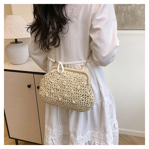 Close-up of beige woven cloud bag featuring gold chain strap and textured fabric